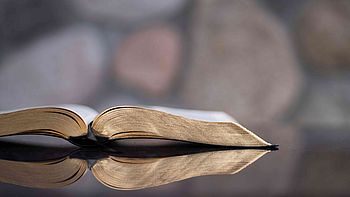 Open book on a table. Image under licence Unsplash